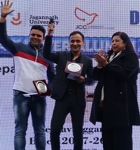 Video thumbnail of two hosts speaking on stage at Alumni Meet 2026