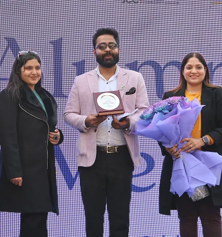 Video thumbnail of two hosts speaking on stage at Alumni Meet 2026